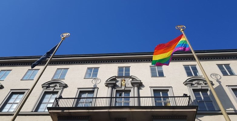 Rainbow flags outside SSE, with blue skies