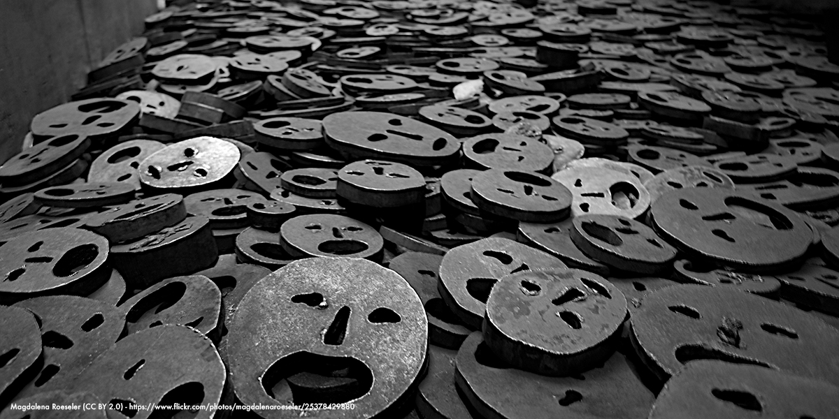 Metal pieces with faces in a pile