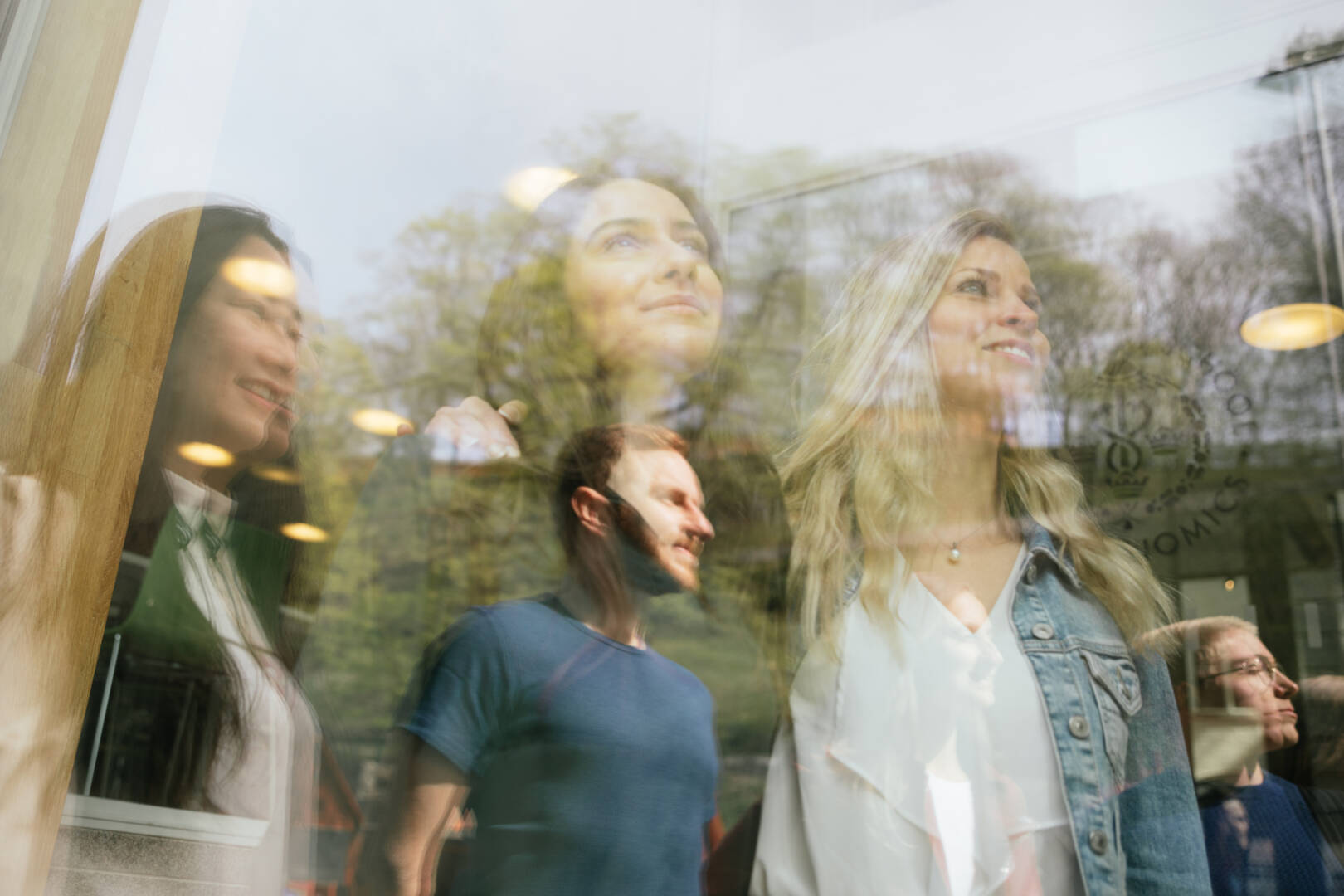 SSE students reflected in glass by the main entrance