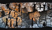 Cracked earth. Shadow people on the edge of the image.