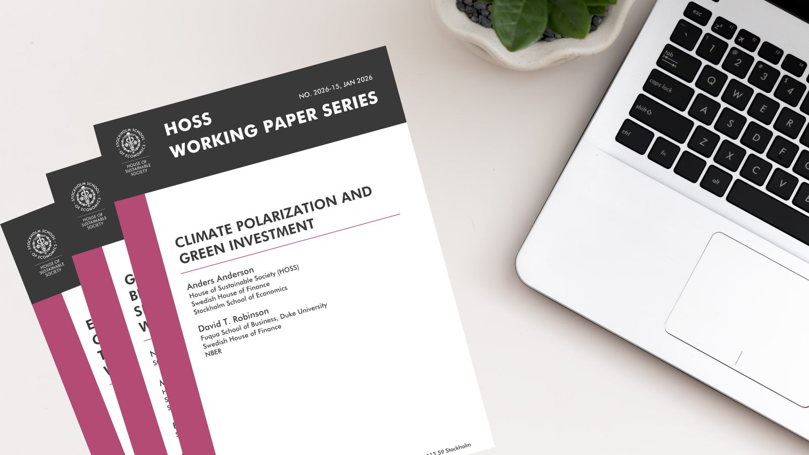 Several HOSS working papers lying on a desk next to a laptop