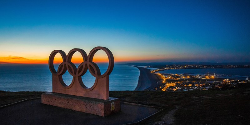 olympic ringa with a sea background