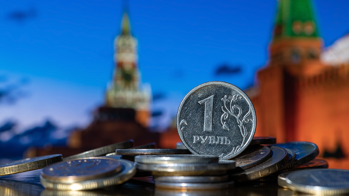 Coin in denomination of one Russian ruble against the background of the towers of the Moscow Kremlin.