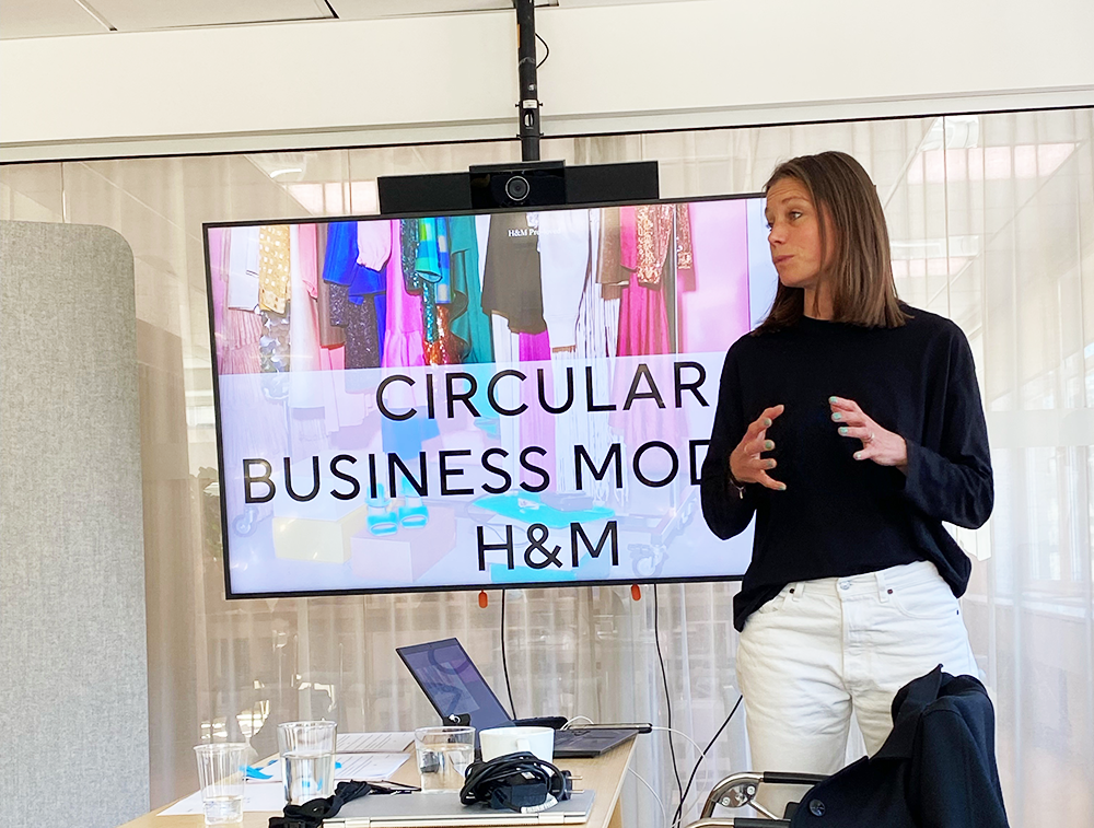 Linn Af Klint, H6M representative holds a presentation in front of a TV screen