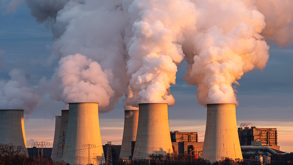 Smoking pipes of thermal power plant on sunset.