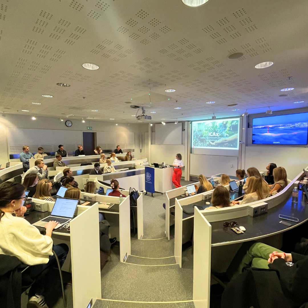 Emma Lindahl, Head of ICAx, holds a presentation in front of a fully seated classroom.