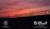 silhouette of barbed wire against sunset sky