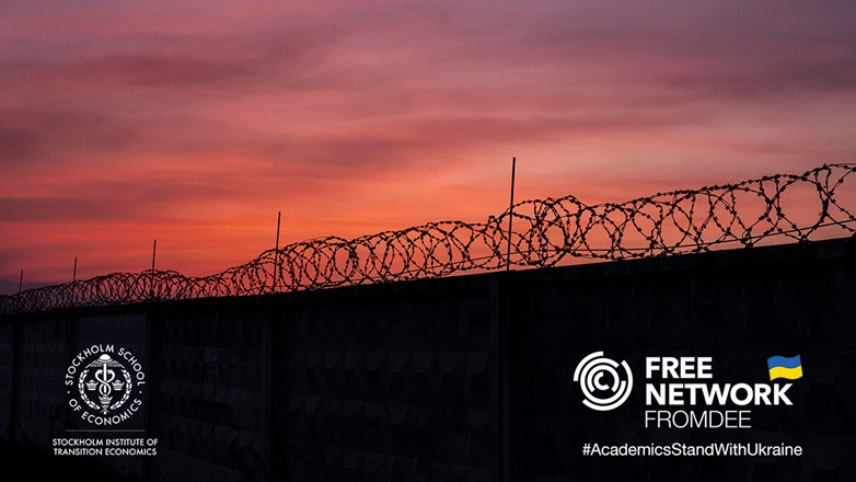 silhouette of barbed wire against sunset sky