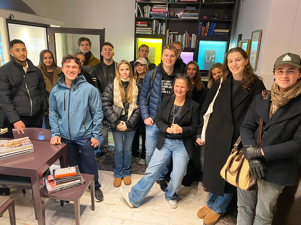 Group of students visiting Gaudi smiling into the camera.