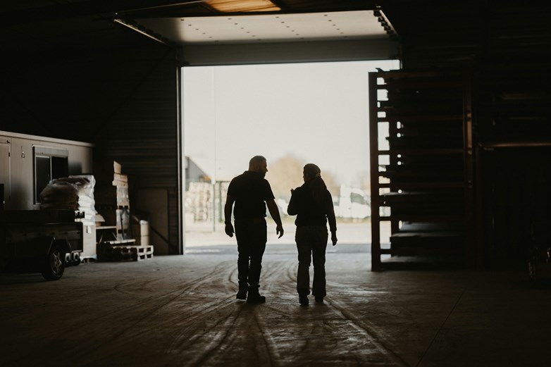 Photo of two men in an industrial building