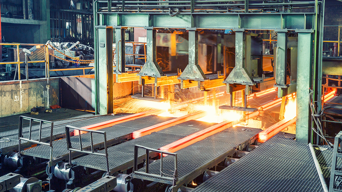 Hot steel on conveyor in steel plant.