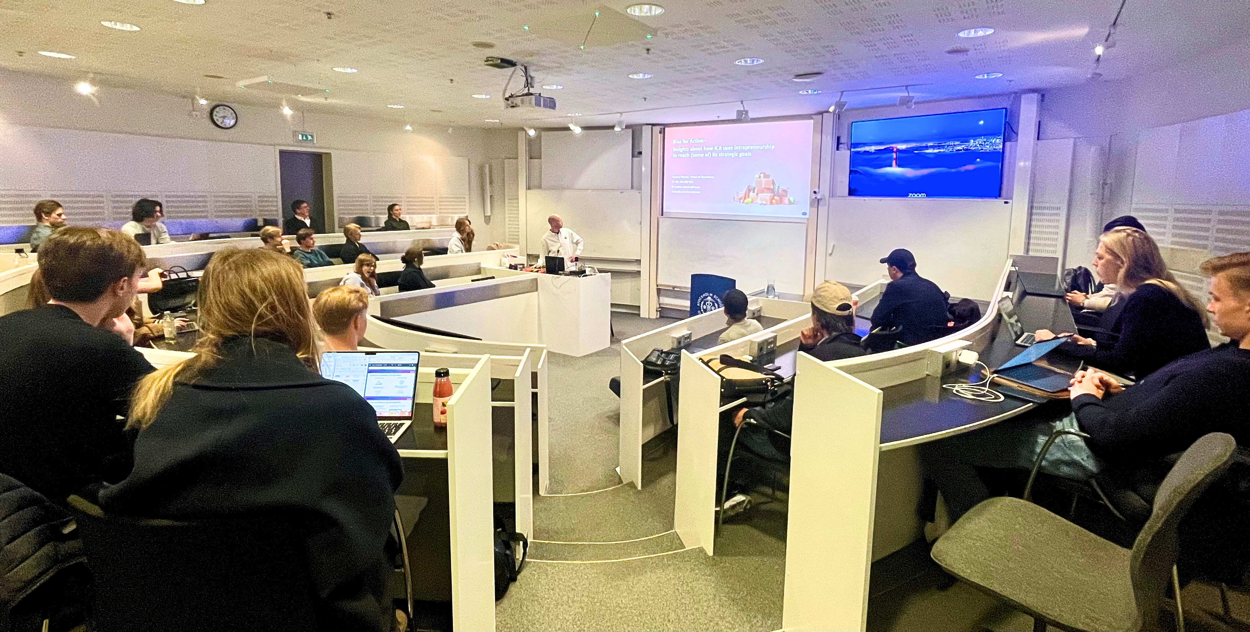 Students listening to a lecture with representatives from ICA paket