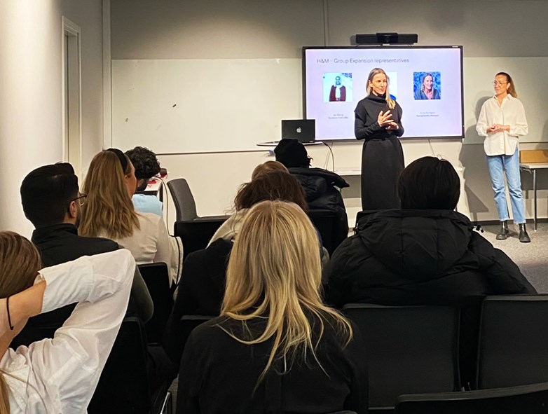 Anna Palmqvist, Sustainability Manager for H&M Group Global Expansion, and collegues holding a presentation in front of a group of students.
