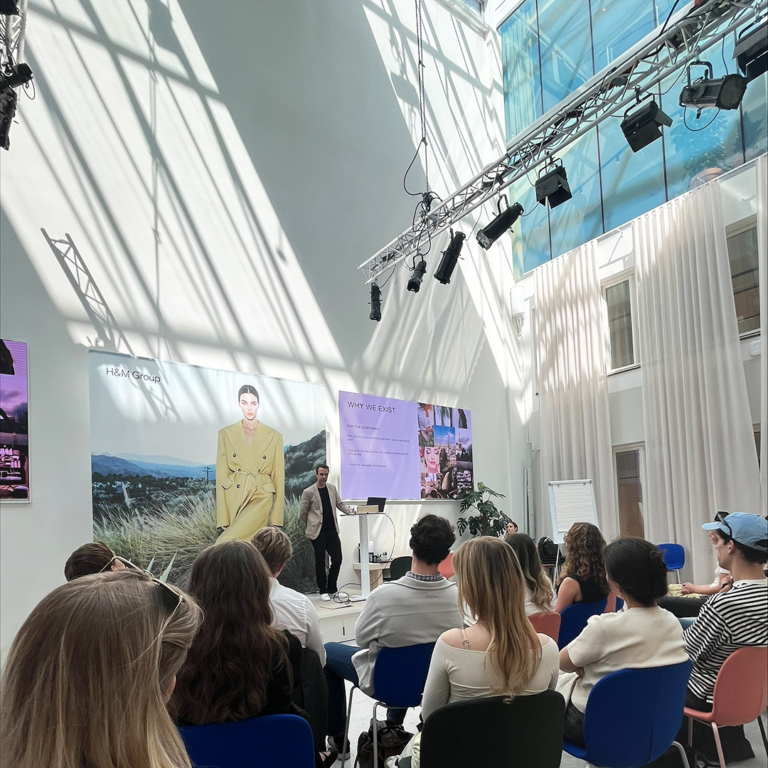 H&M representative holding a presentation for students at H&M's HQ.