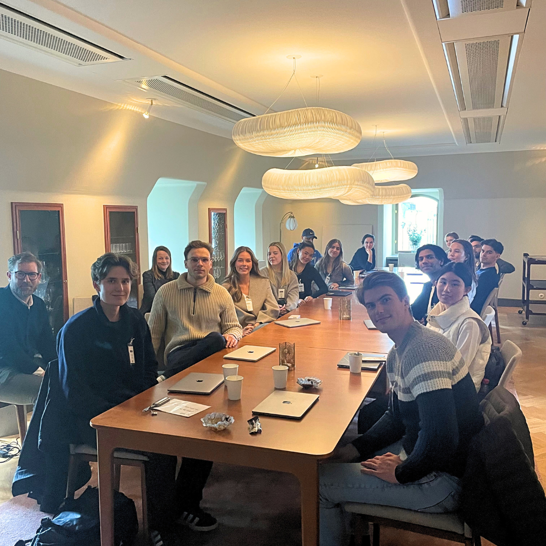 Students sitting around a conference table at HUR Research Stockholm in a workshop format.
