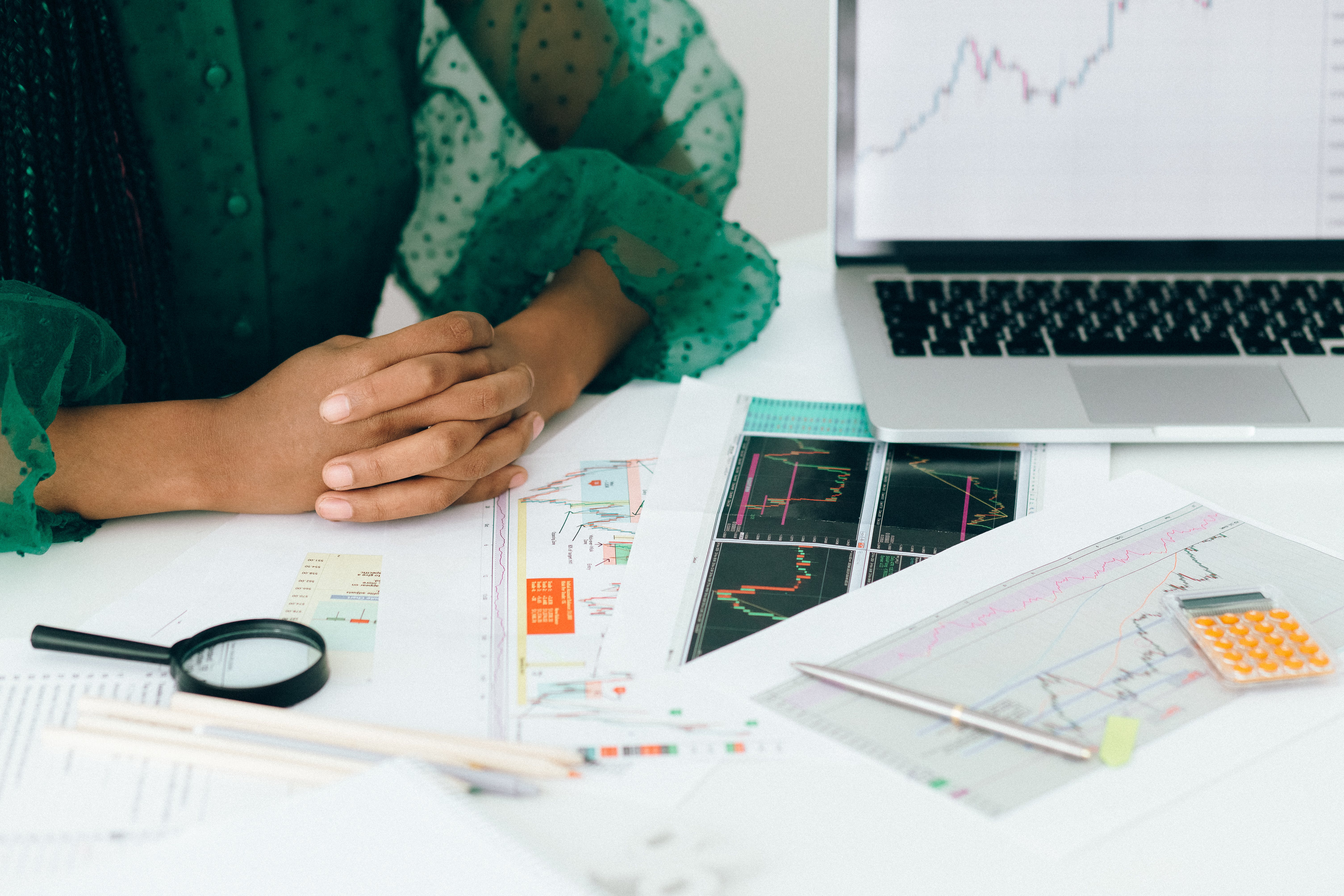 Photo of person at a desk with paper with graphs