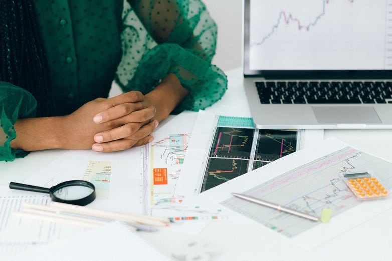 Photo of person at a desk with paper with graphs
