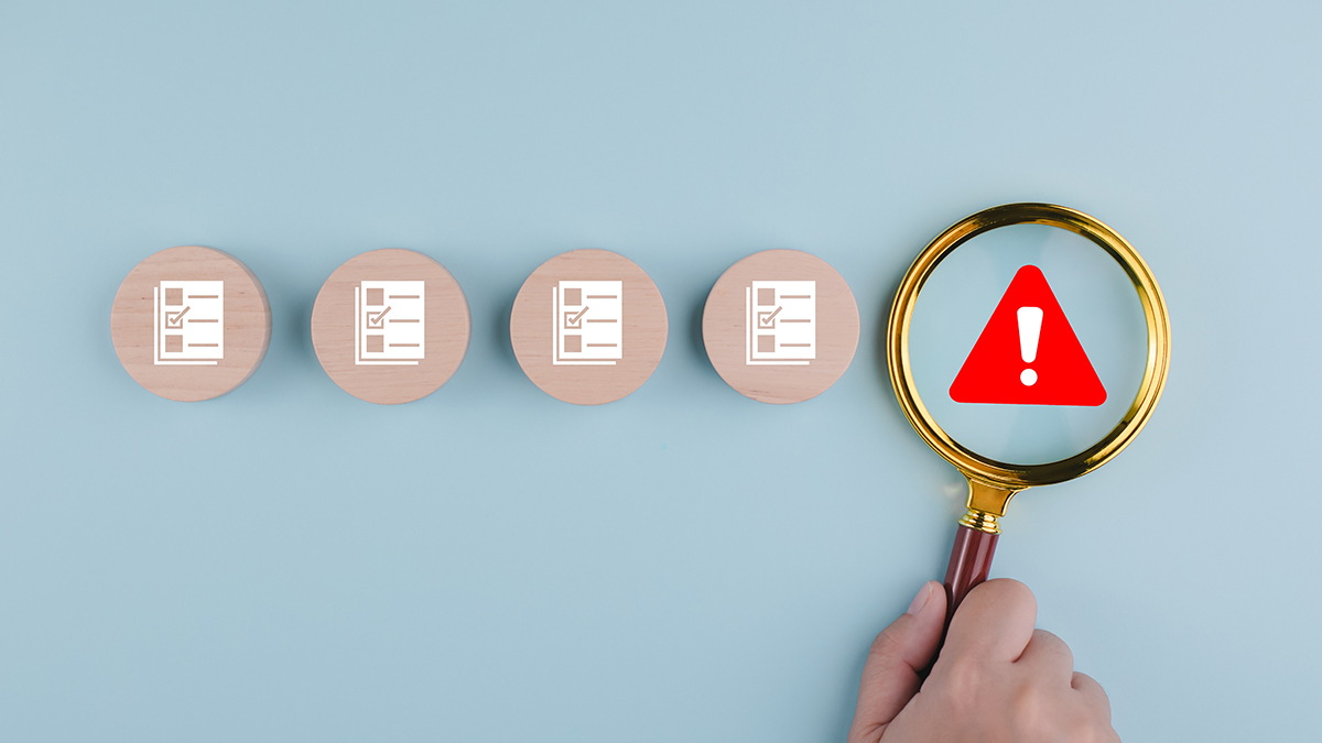 Man is holding magnifying glasses under the concept of warning alerts, caution icon ,organization's database.Electronics documentation