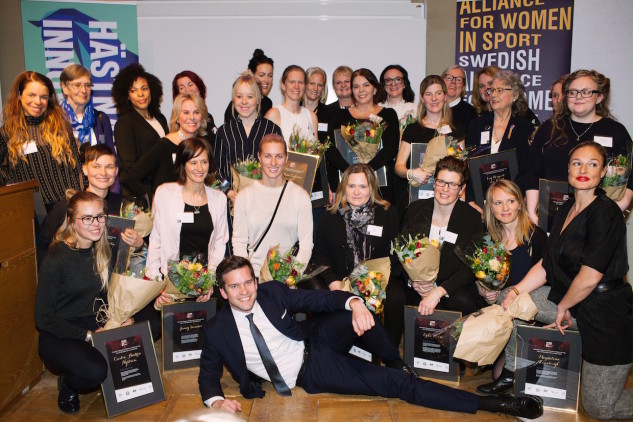 people sitting on the ground on a sports galsa