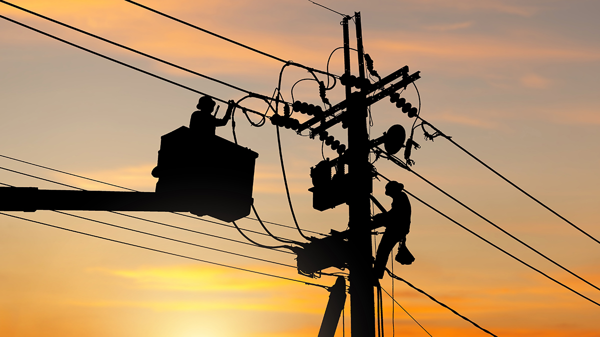 Silhouette of Electrician officer climbs a pole and uses a cable car to maintain a high voltage line system, Shadow of Electrician lineman repairman worker at climbing work on electric post power pole