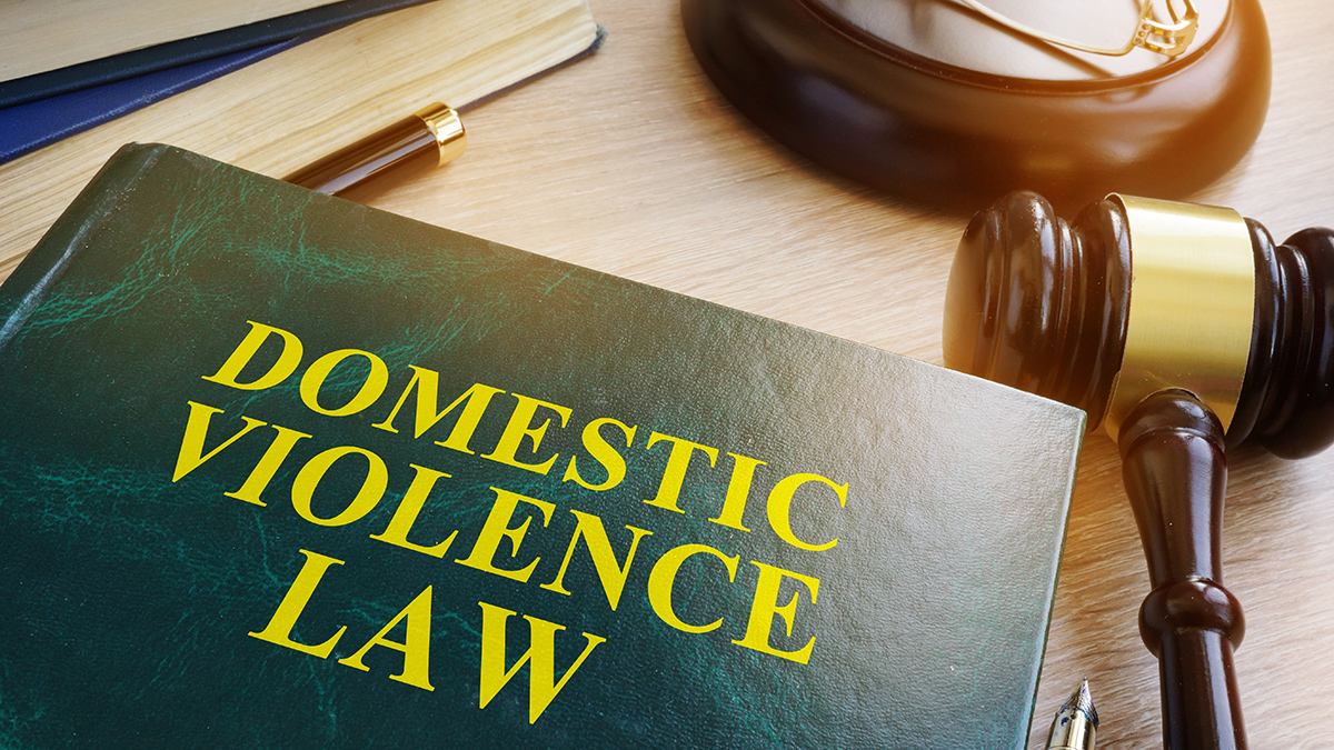 Domestic violence law on a wooden table.