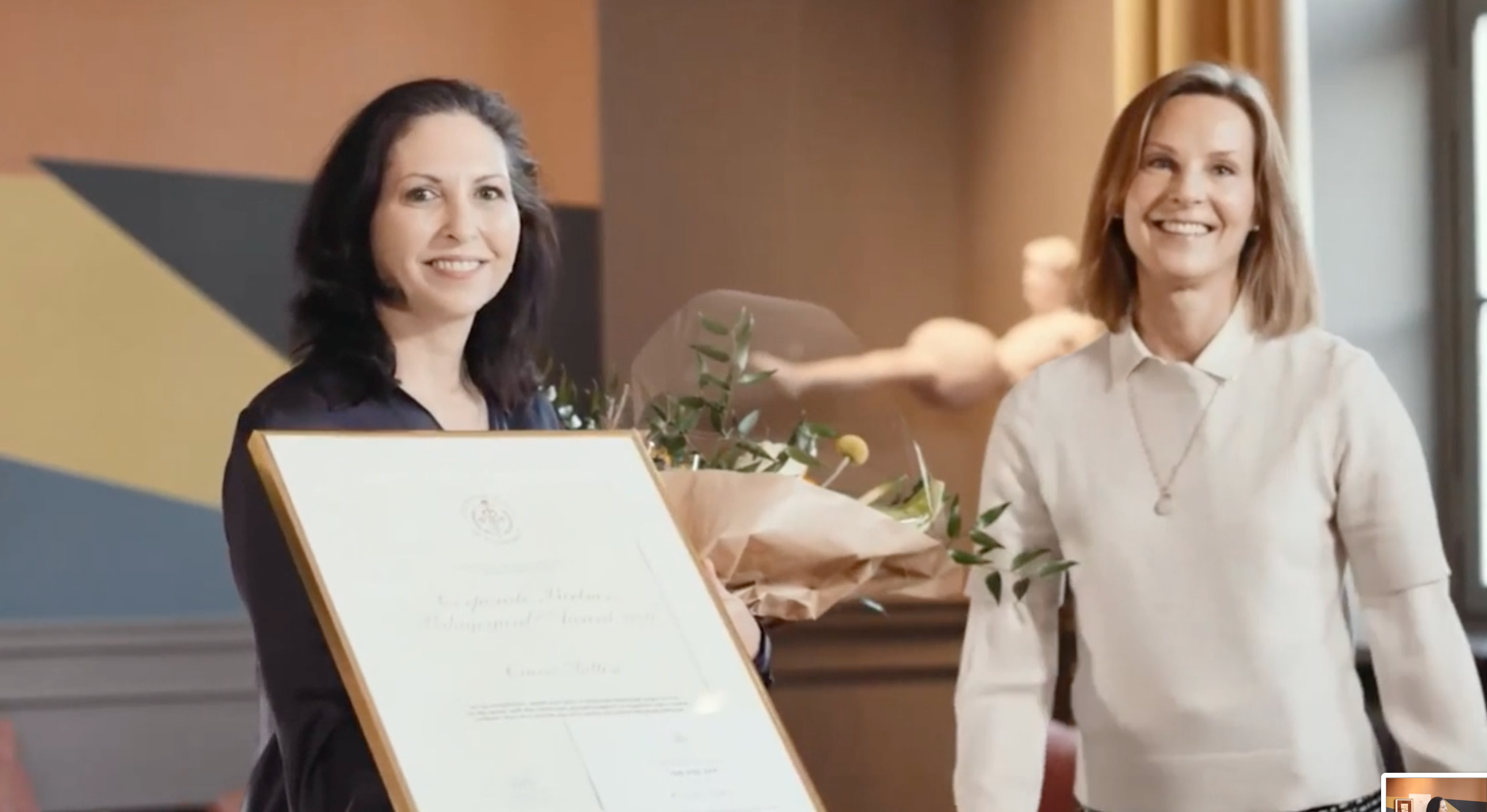 Ciara Sutton with flowers and her diploma together with Helena Saxon