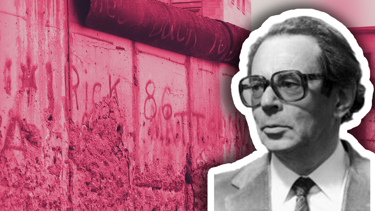 Image of János Kornai and a picture of the Berlin Wall in the background