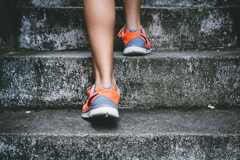 Photo of running shoes walking up stairs