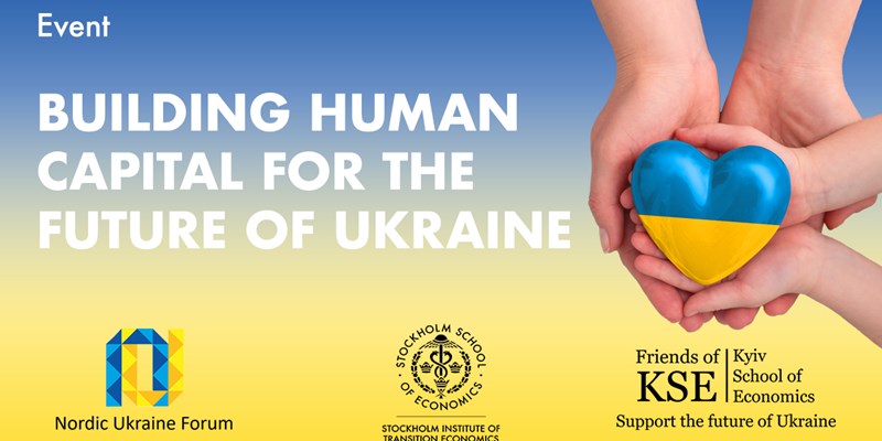 An adult, mother, father and child hold a Ukraine heart in their hands.