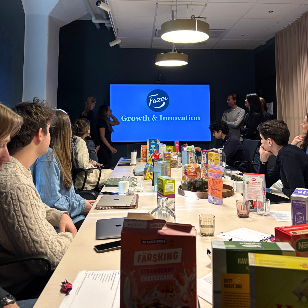 Students presenting at a workshop in a conference room at Fazer HQ.