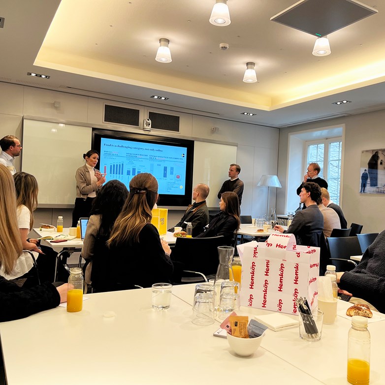 Company representatives from Axel Johnson present in front of group of students in a conference room.