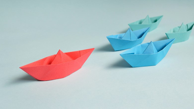 Several origami boats placed on a flat surface.