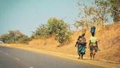 African women are walking along the road