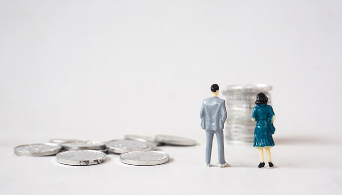 Man and women miniature standing on pile of coin. Equality gender on working salary photo concept