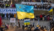 activist or protester holding a Ukrainian flag at a public demonstration or meeting supporting Ukraine in Estonia, Tallinn