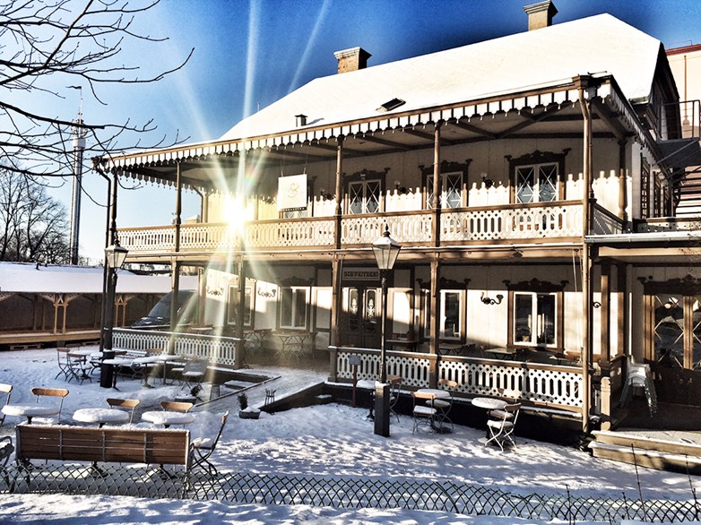 The Snus & Tändsticks museum at Skansen in a snowy landscape and sunny sky.
