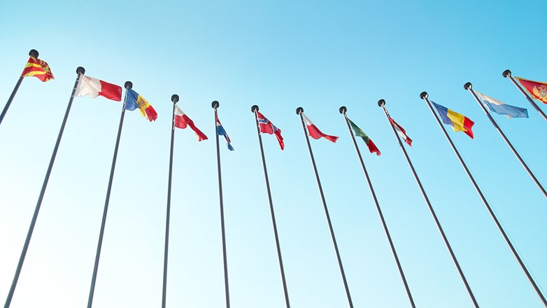 Row of European flags against blue sky background