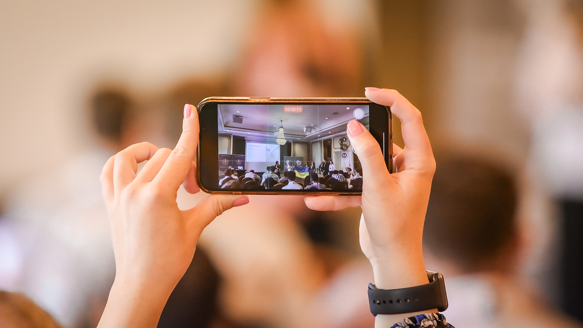 A woman taking a photo via her smart phone