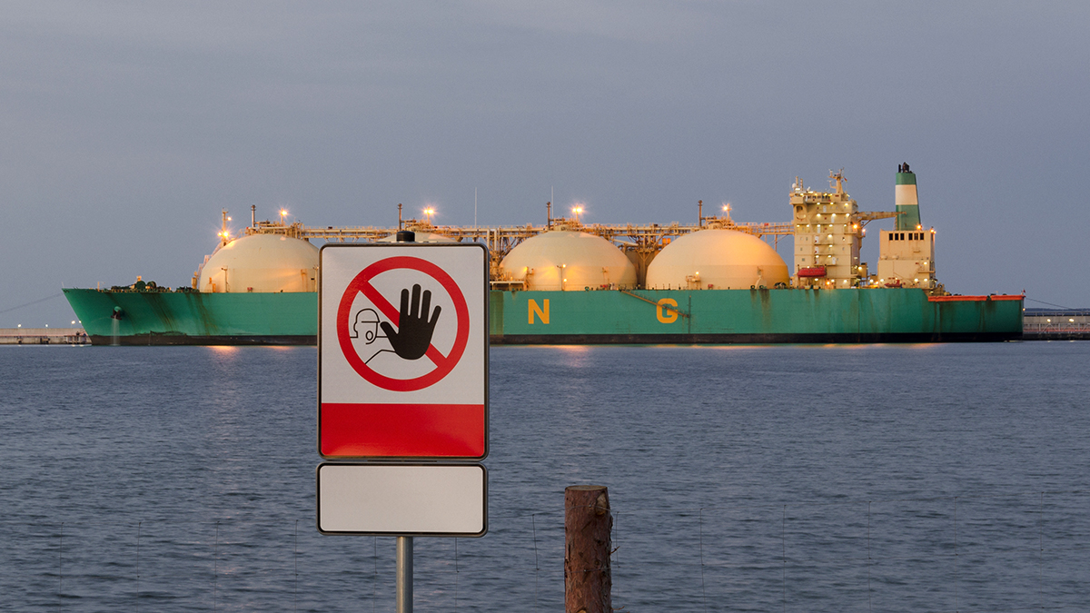 SIGN "NO ENTRY" AND LNG TANKER - Ship at night moored to the gas terminal