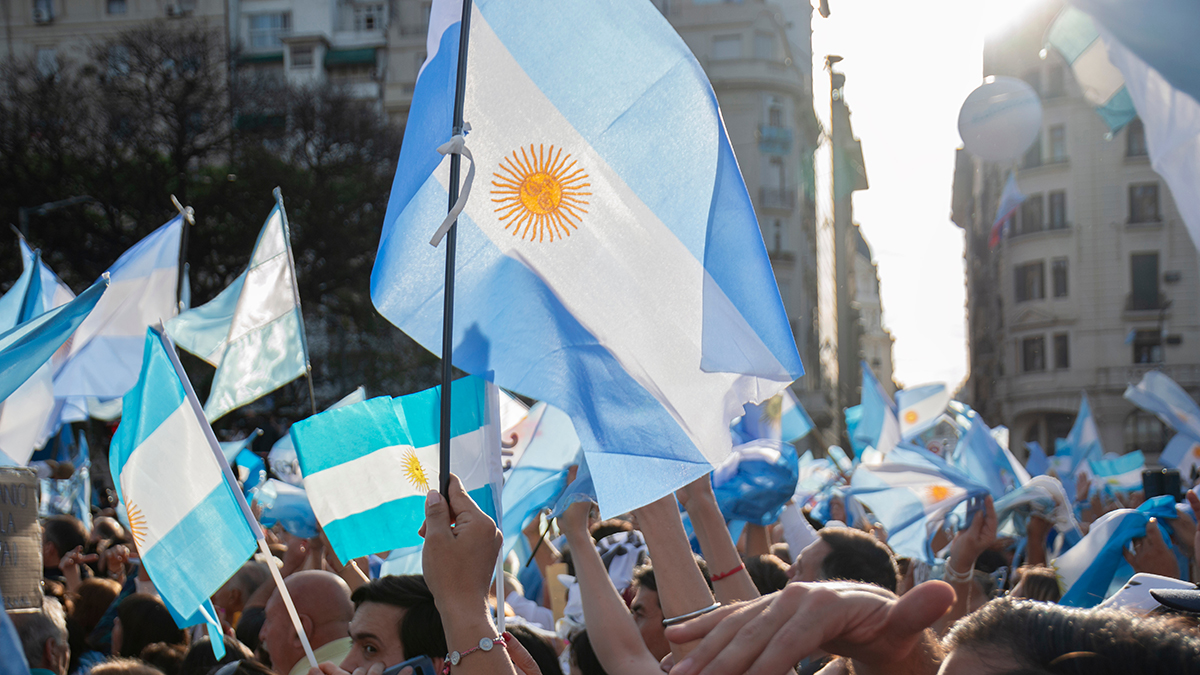 A crowd of people with Argentine flags.