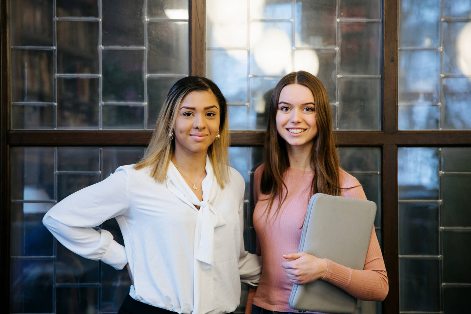 two students smiling in front of the camera