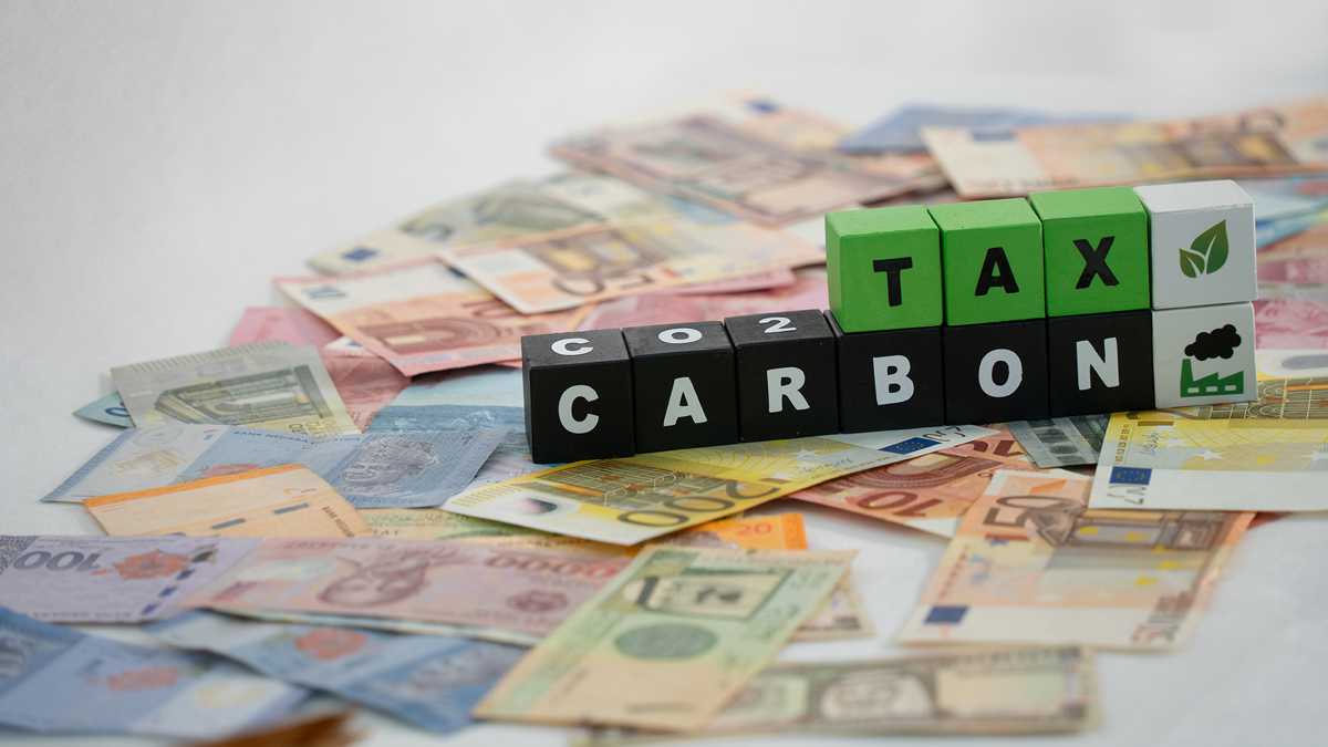 CO2 Carbon Tax write on color cubes over various currencies in the world. Photo: Shutterstock