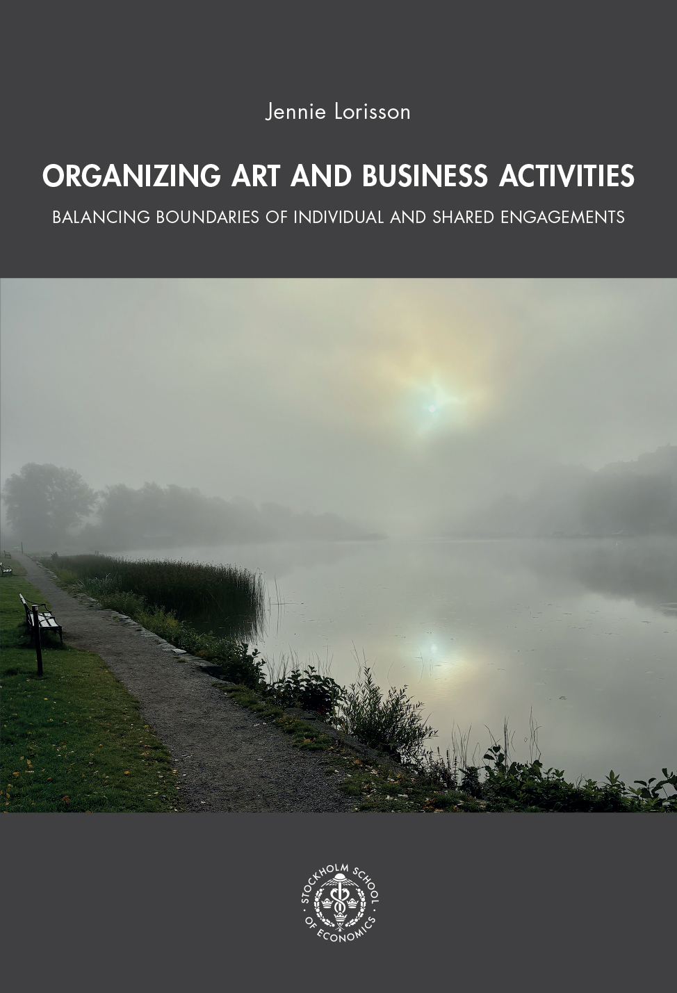 Book cover image: a foggy lakeside scene shows a calm body of water reflecting a muted sun, with a gravel path, benches, and tall grasses along the shore fading into the mist.