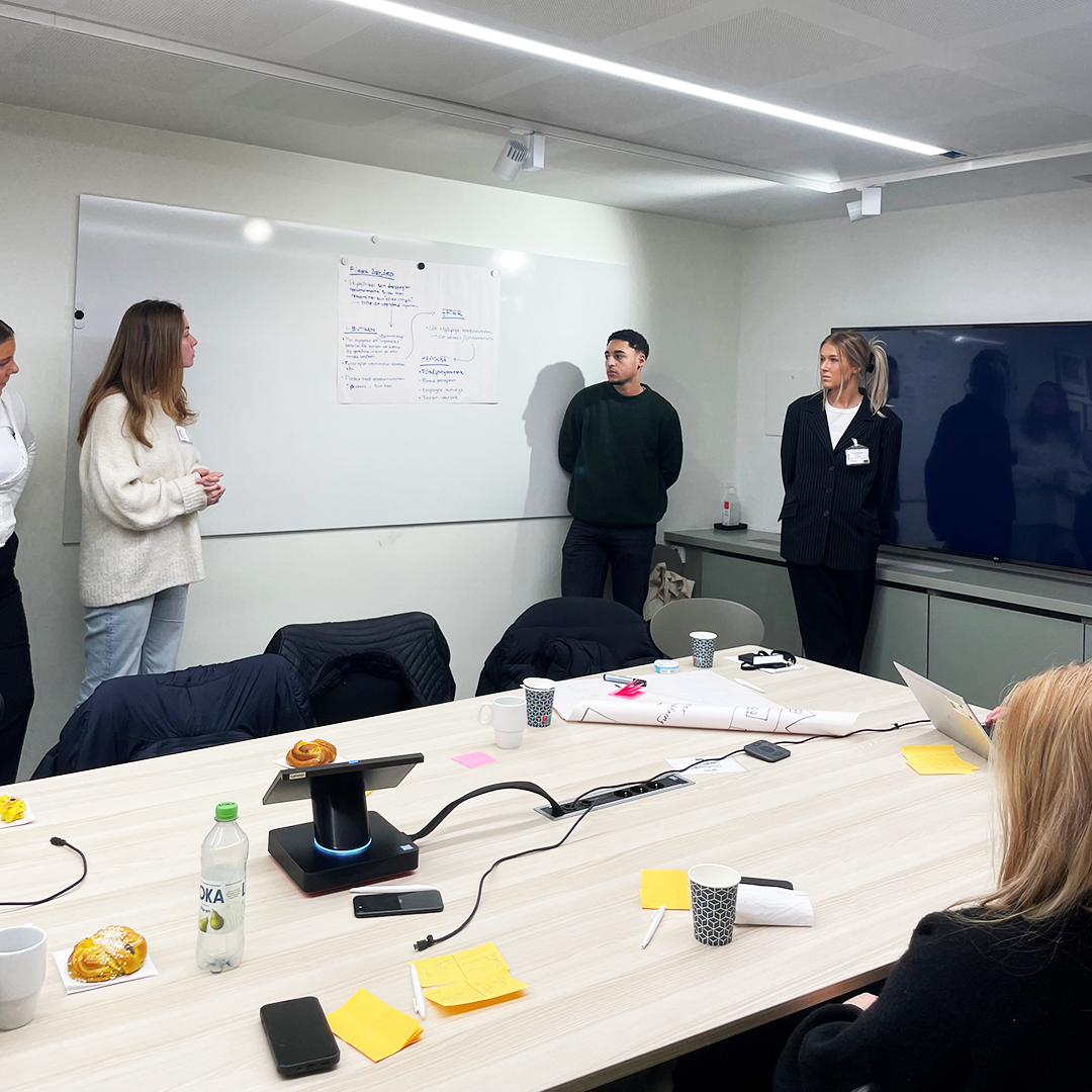 Students presenting in front of a whiteboard