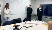 Students presenting in front of a whiteboard