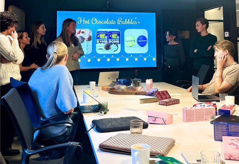 Students presenting at a workshop with Fazer