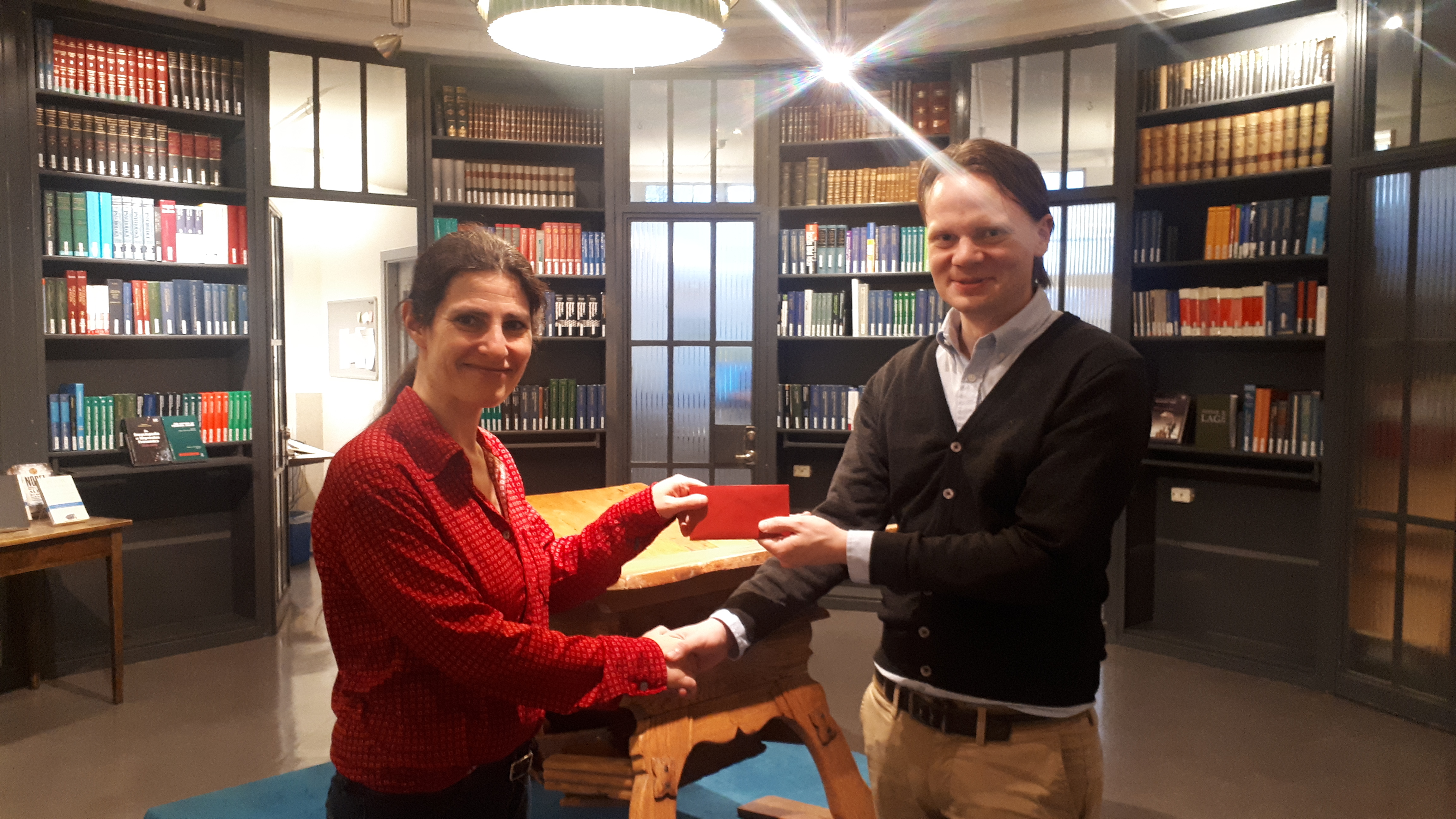 Gabriel is handed the prize by Library Manager Miriam Nauri