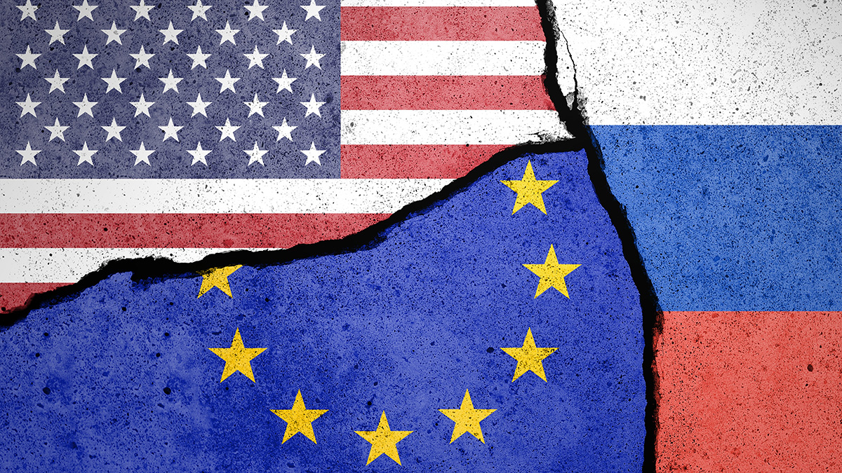 Flags of US, EU and Russia painted on cracked wall
