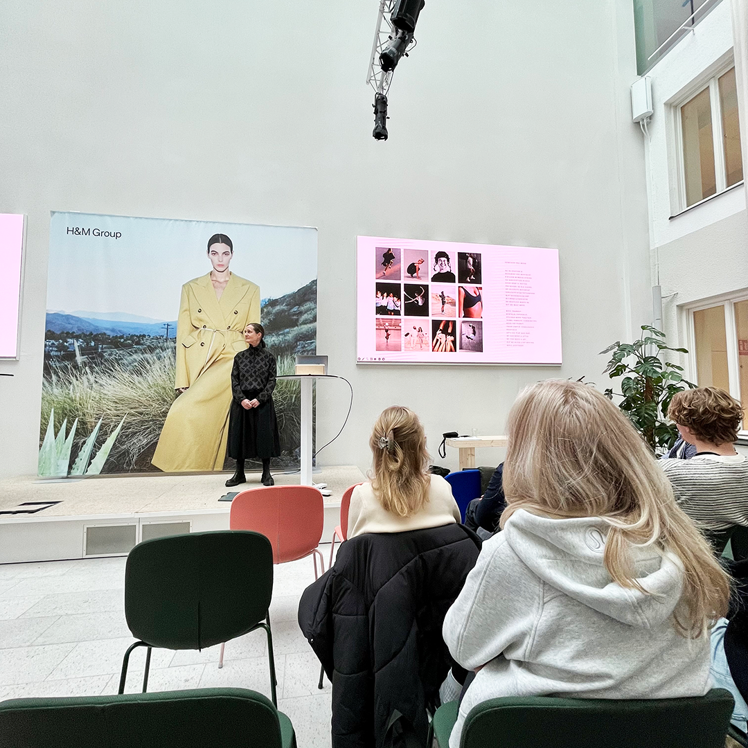 H&M representative holding a presentation in fron of students at H&M HQ
