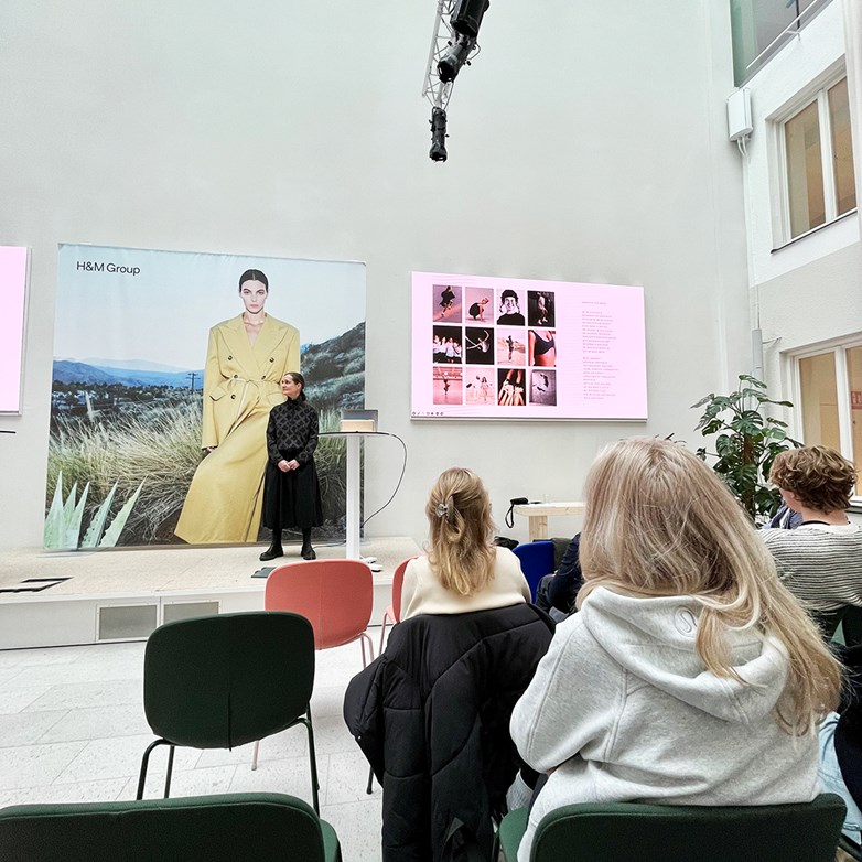 H&M representative holding a presentation in fron of students at H&M HQ